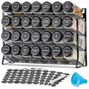 Spice rack organizer with 28 glass jars, black lids, and labels, displayed on a kitchen countertop