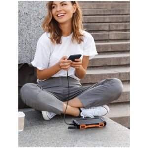 Portable 42800mAh Power-Bank-Solar-Charger used in outdoor environment with sunlight and nature background