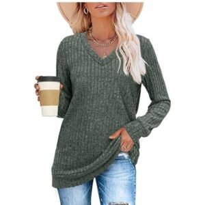 Women wearing a lightweight V-neck long sleeve tunic sweater, holding a cup of coffee