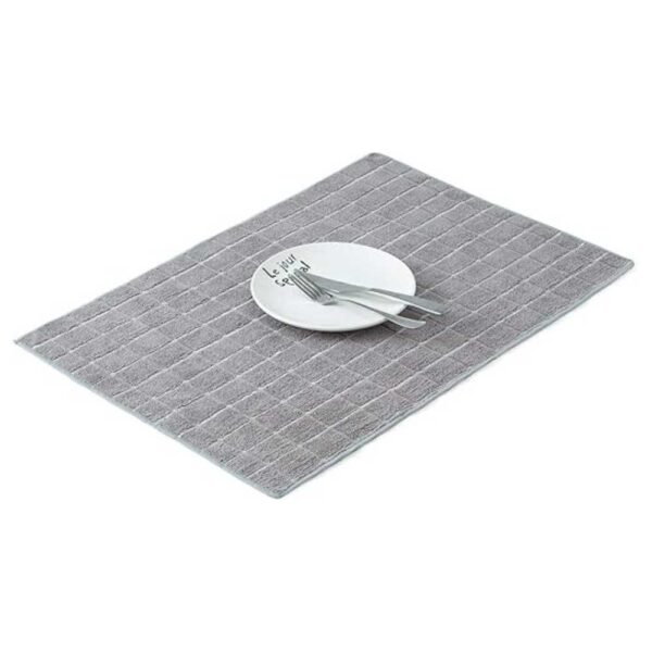 Dish towel neatly laid under a plate, protecting surfaces and adding a decorative touch to the kitchen