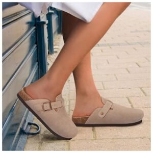 Woman wearing stylish leather clogs with vintage tones and a comfortable fit, perfect for casual outings.