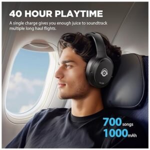 erson wearing Hybrid Active Noise Cancelling Headphones in an office setting, highlighting comfort and noise reduction for work or travel