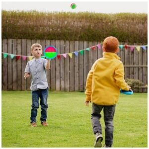 Children having fun playing the toss and catch ball game outdoors in the yard.