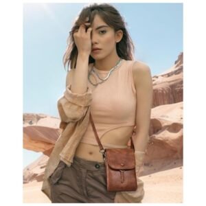 Model wearing a soft leather crossbody bag, demonstrating its size and style in a real-life setting.