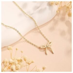 Close-up of 14K gold bow necklace for women, showcasing its trendy design.