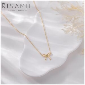 Close-up of 14K gold bow necklace for women, showcasing its trendy design.