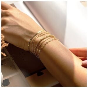 Woman wearing stackable 14K gold bracelets