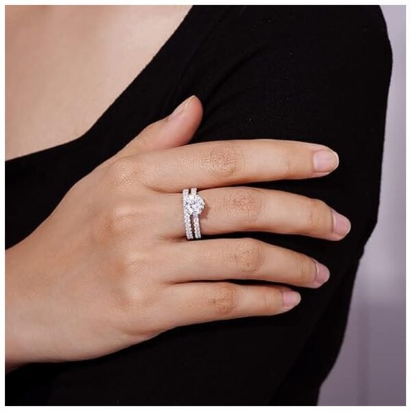 Elegant woman’s fingers adorned with the platinum or gold plated sterling silver ring set featuring Infinite Elements Zirconia