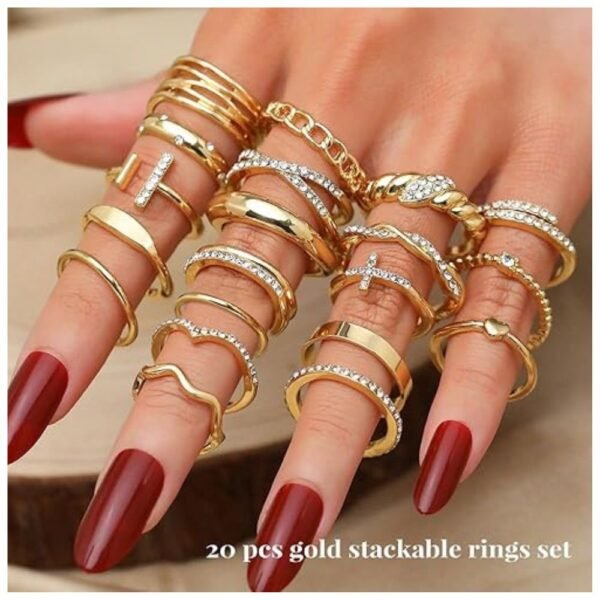 A hand wearing several stacked rings from the gold knuckle rings set, showcasing multiple designs