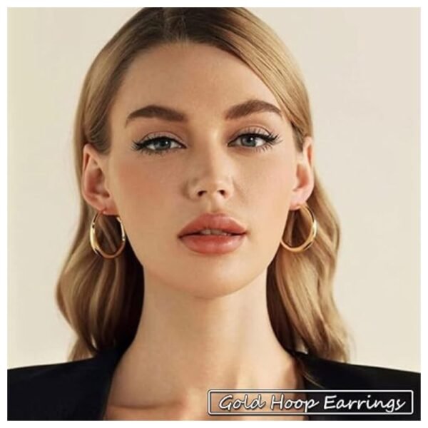 Woman wearing a pair of gold hoop earrings from the 36 pairs set, styled for a chic look