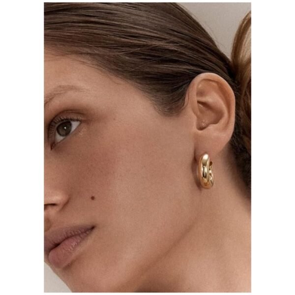 Women wearing waterproof, hypoallergenic gold hoop earrings with a stylish look