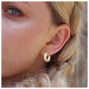 Woman wearing different pairs of gold hoop earrings from the set, demonstrating various styles like chunky hoops and huggies.