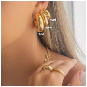 Multiple styles of chunky gold hoop earrings including thick and thin designs
