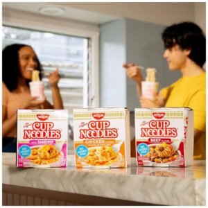 A couple enjoying a comforting bowl of Nissin Cup Noodles Soup together, perfect for a quick meal.