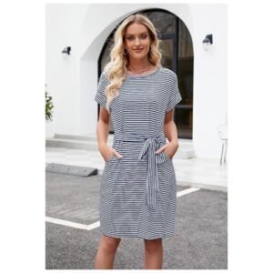 Model wearing women's striped t-shirt dress, showcasing its flattering fit, tie waist, and side pockets for a chic look.