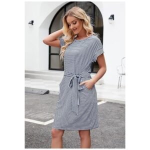 Model wearing women's striped t-shirt dress, showcasing its flattering fit, tie waist, and side pockets for a chic look.