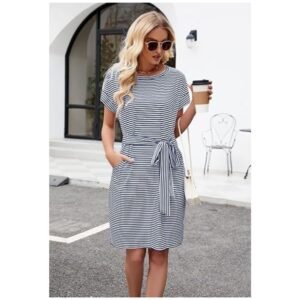 Model wearing women's striped t-shirt dress, showcasing its flattering fit, tie waist, and side pockets for a chic look.